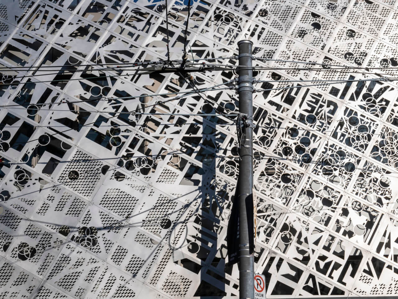 A laser map cut into a steel facade