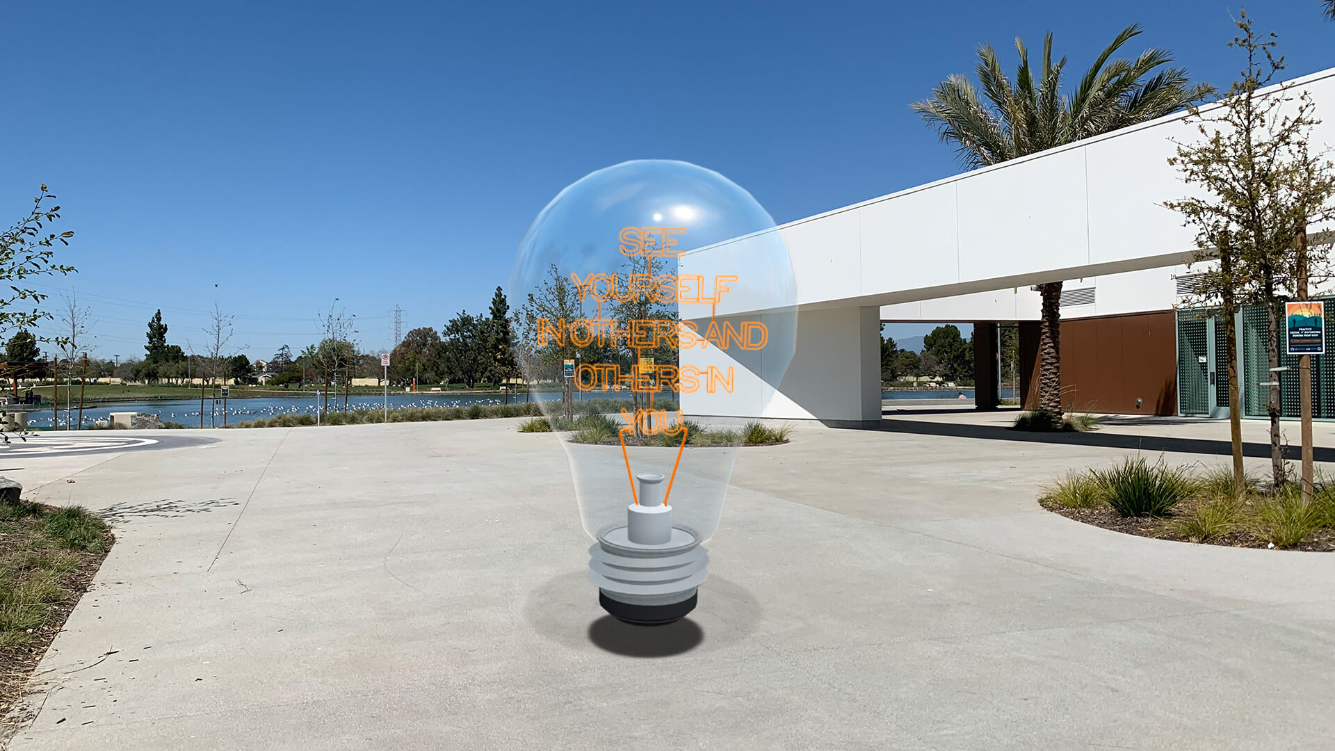 A giant lightbulb floating on concrete part of the monumental perspectives show