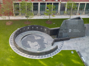 Aerial image of a sunken memorial in granite and concrete on the lawn of the African Burial Ground National Monument
