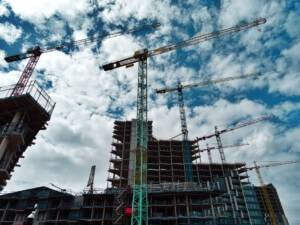 Cranes towering over a skyline, a metaphor for the strong The March Architecture Billings Index