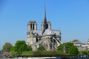Notre dame cathedral as it stood pre-fire, with a tall spire in the center