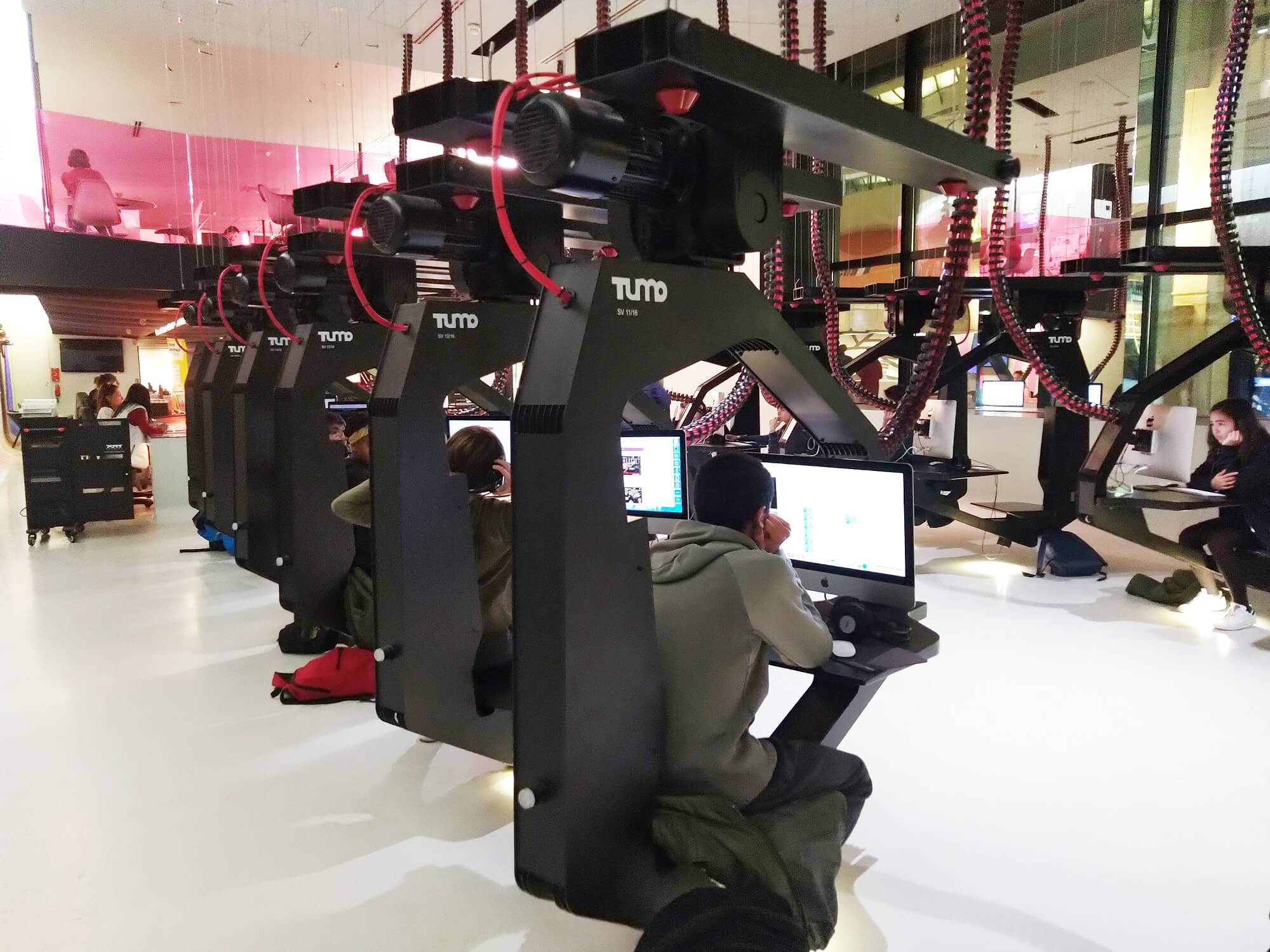 rows and rows of students jacked into freestanding VR setups