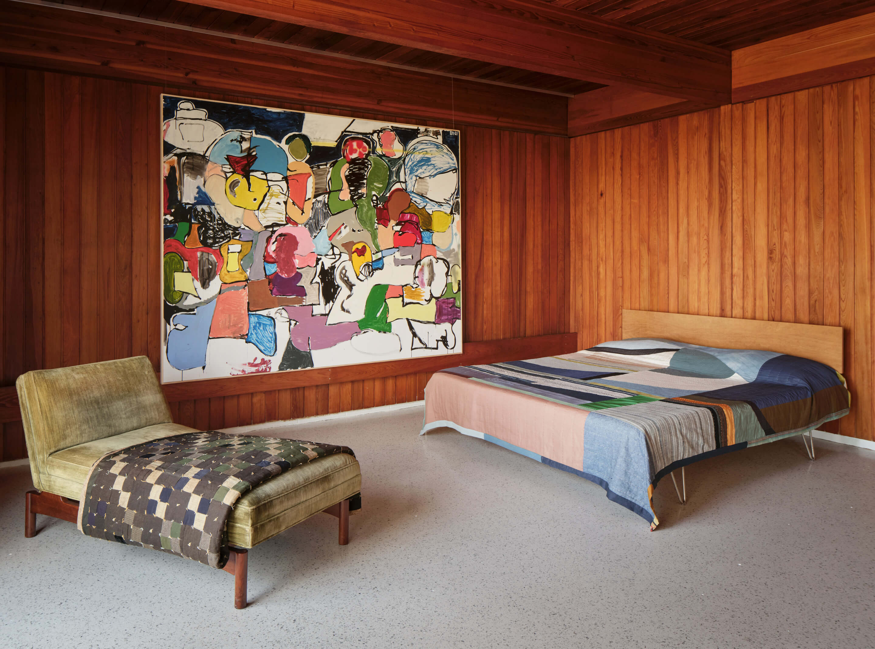 Inside the wood paneled Luss House, with two day beds