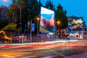 artwork of an explosion in a forest scene on the LED billboard of wiscombe's sunset spectacular
