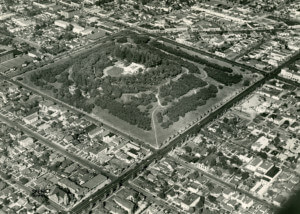 black and white photo depicting an aerial view of a park