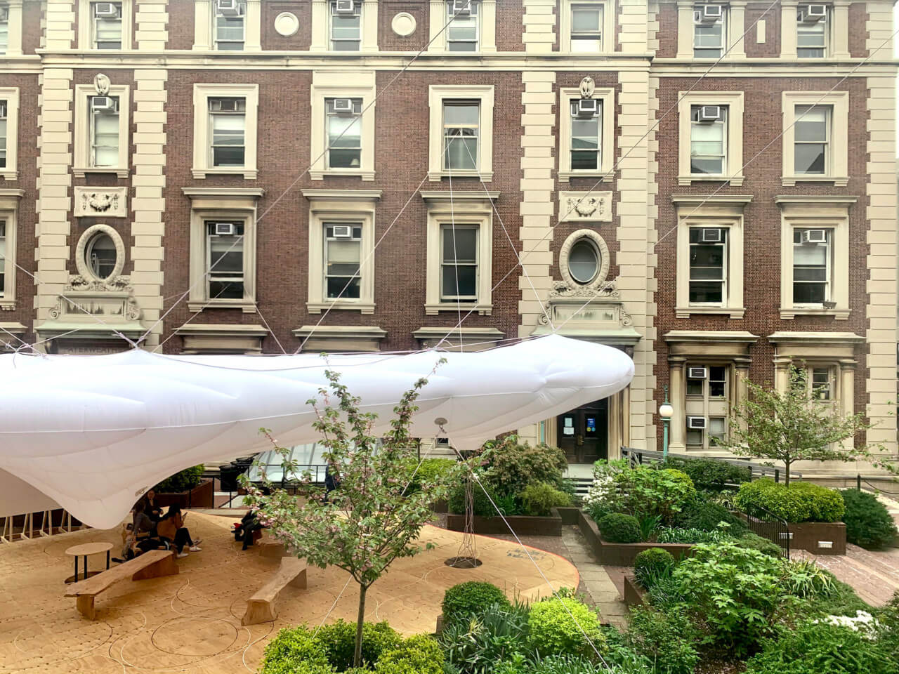a white inflatable tube anchored to a historic college building