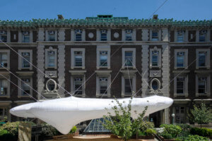 an inflatable pavilion anchored between three neoclassical red brick buildings