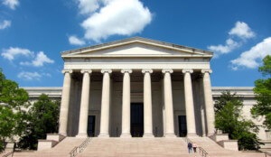 a neoclassical building with columns, a capital building the likes of which the U.S. Commission of Fine Arts would have authority over