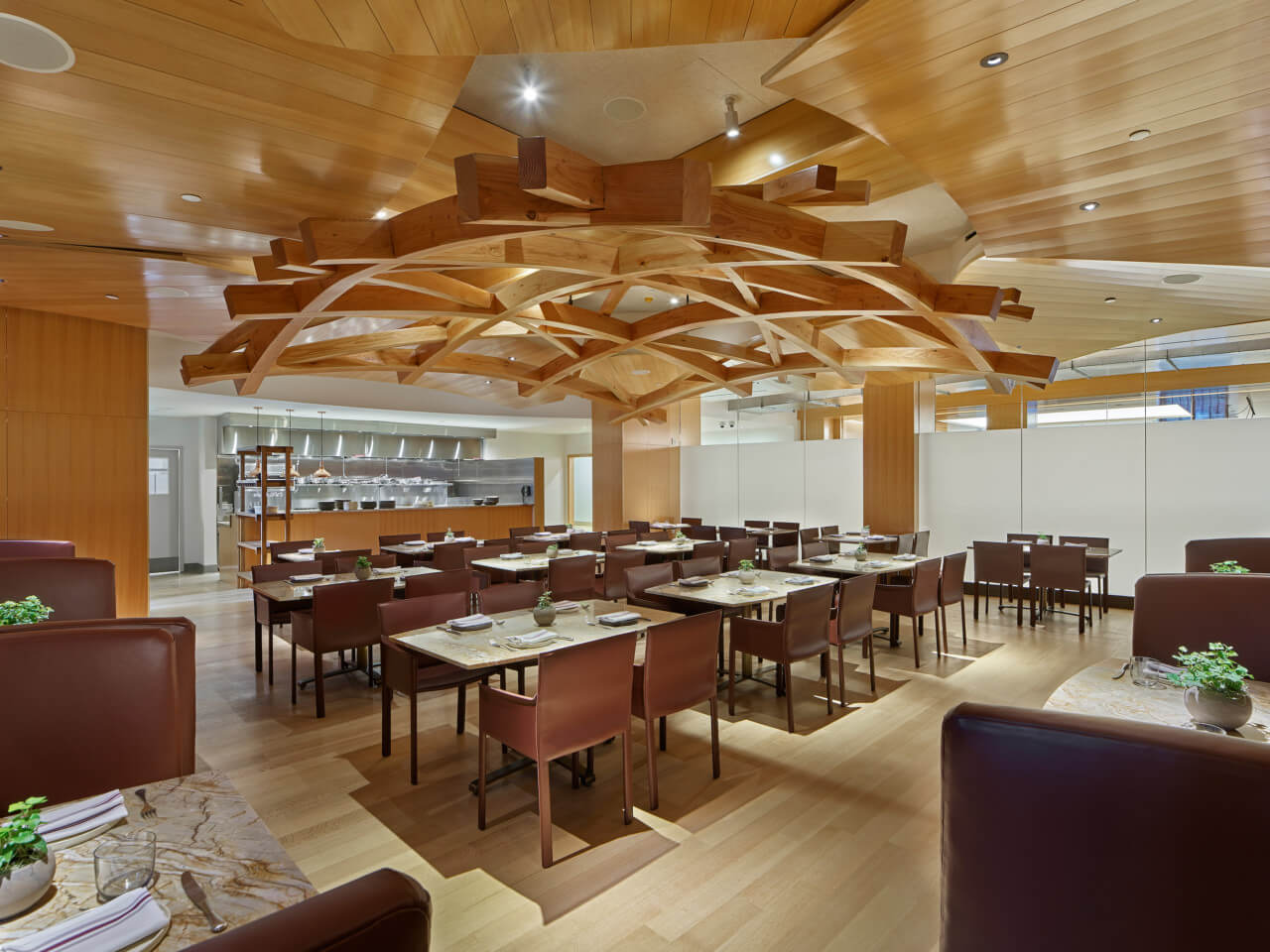interior of a cafe with a sculpture wood installation on the ceiling
