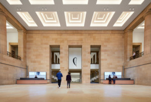museum visitors walk through a soaring main entrance hall