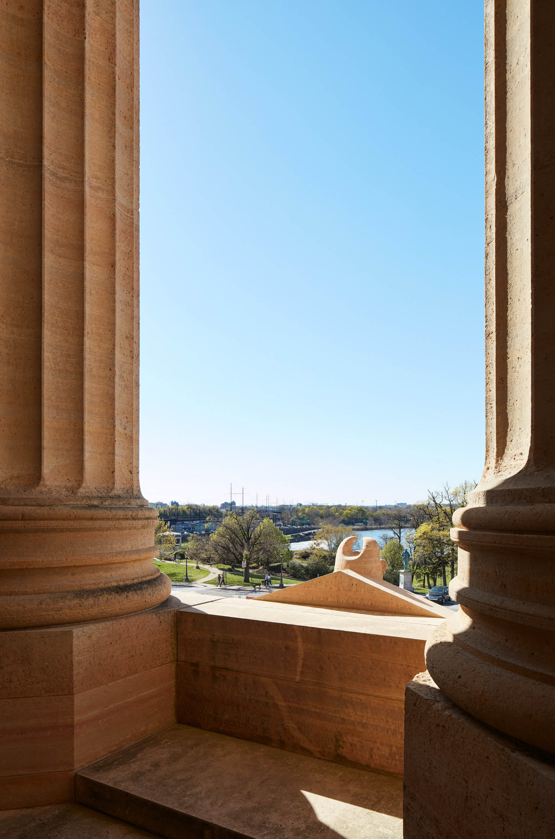 a view of a blue sky and parkland from a portico