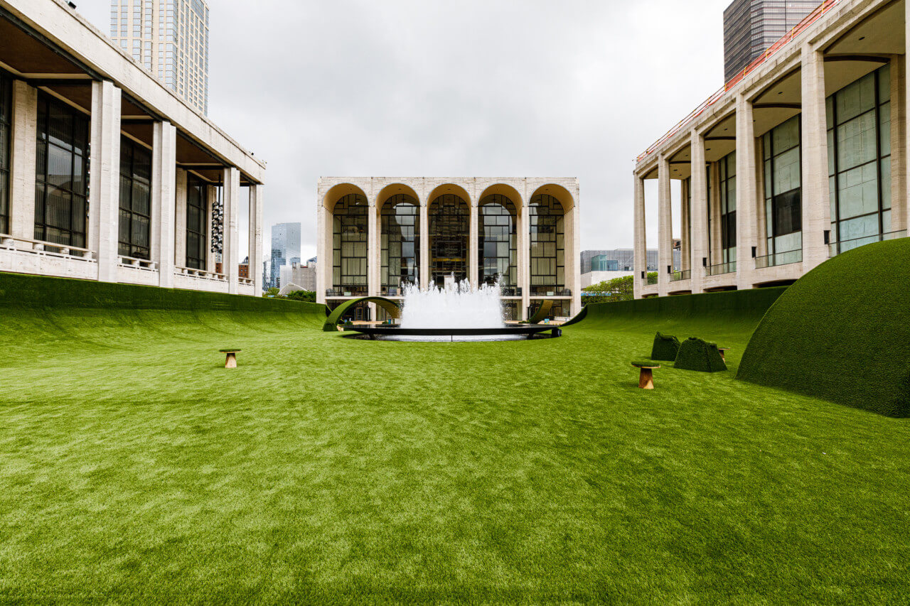 looking at the plaza of lincoln center covered in a fake lawn