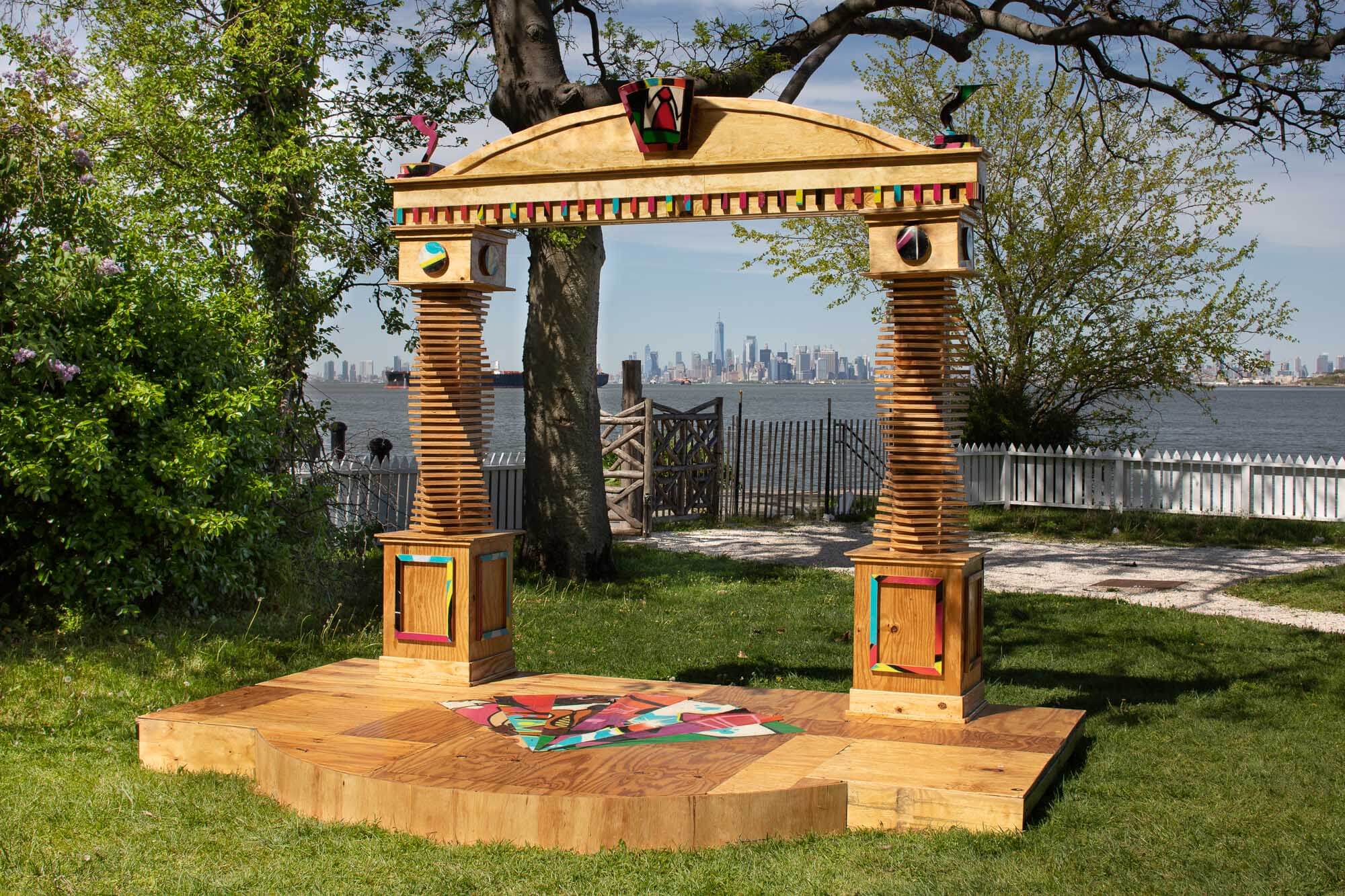 a small hand-crafted performance stage crafted from plywood in a city park