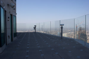 views from a skyscraper's outdoor observation terrace, with skyslide below