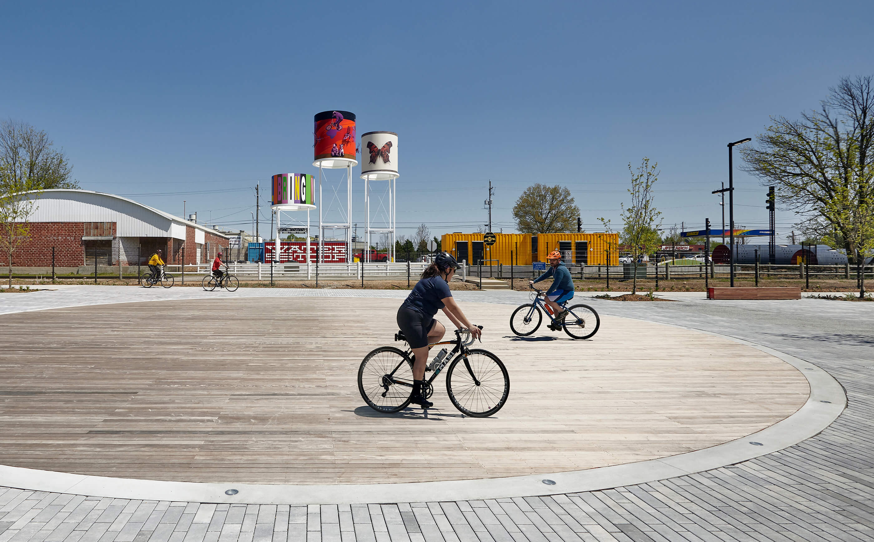 People riding bikes around on a wooden surface
