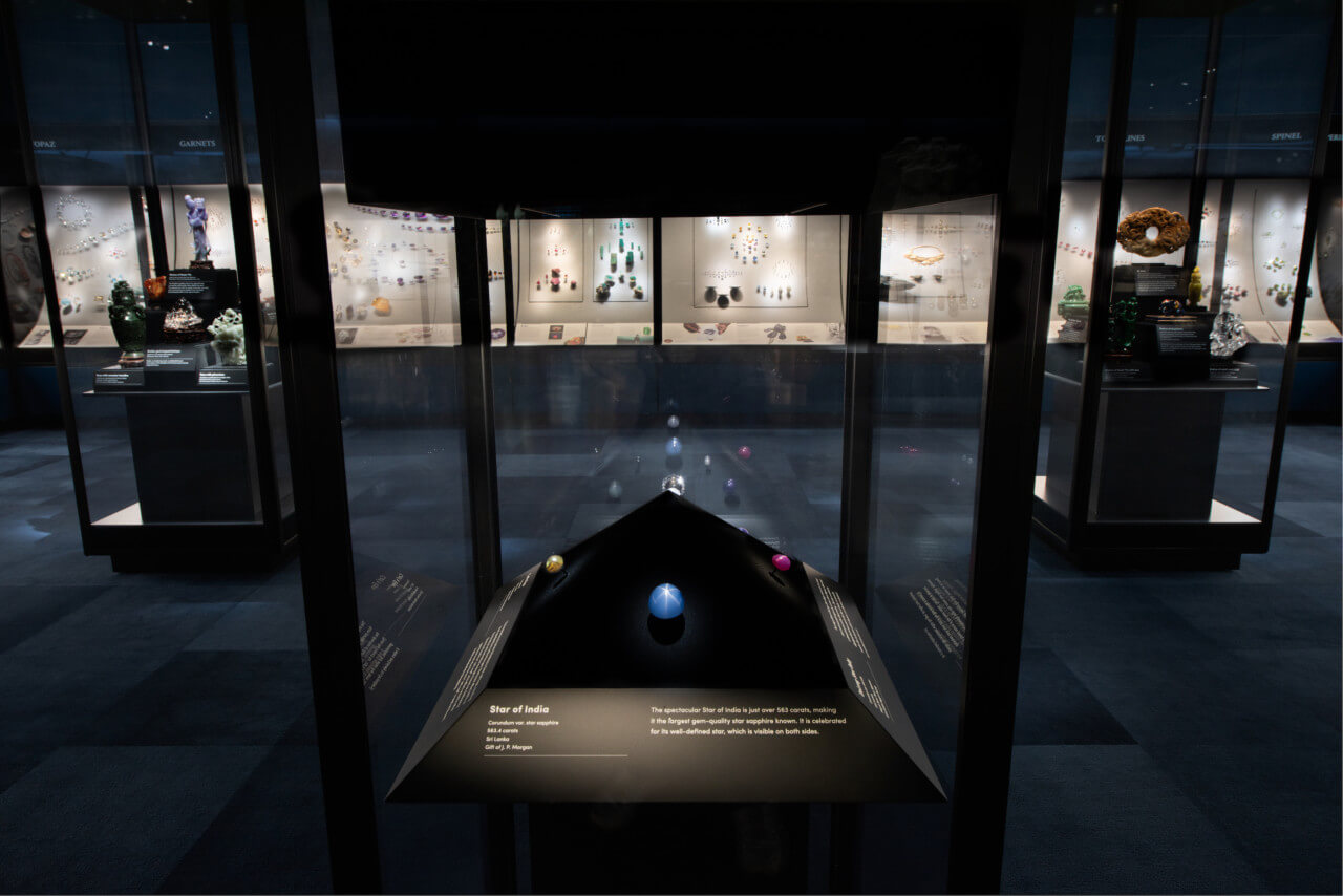 a view of a museum hall with precious gems on display in cases