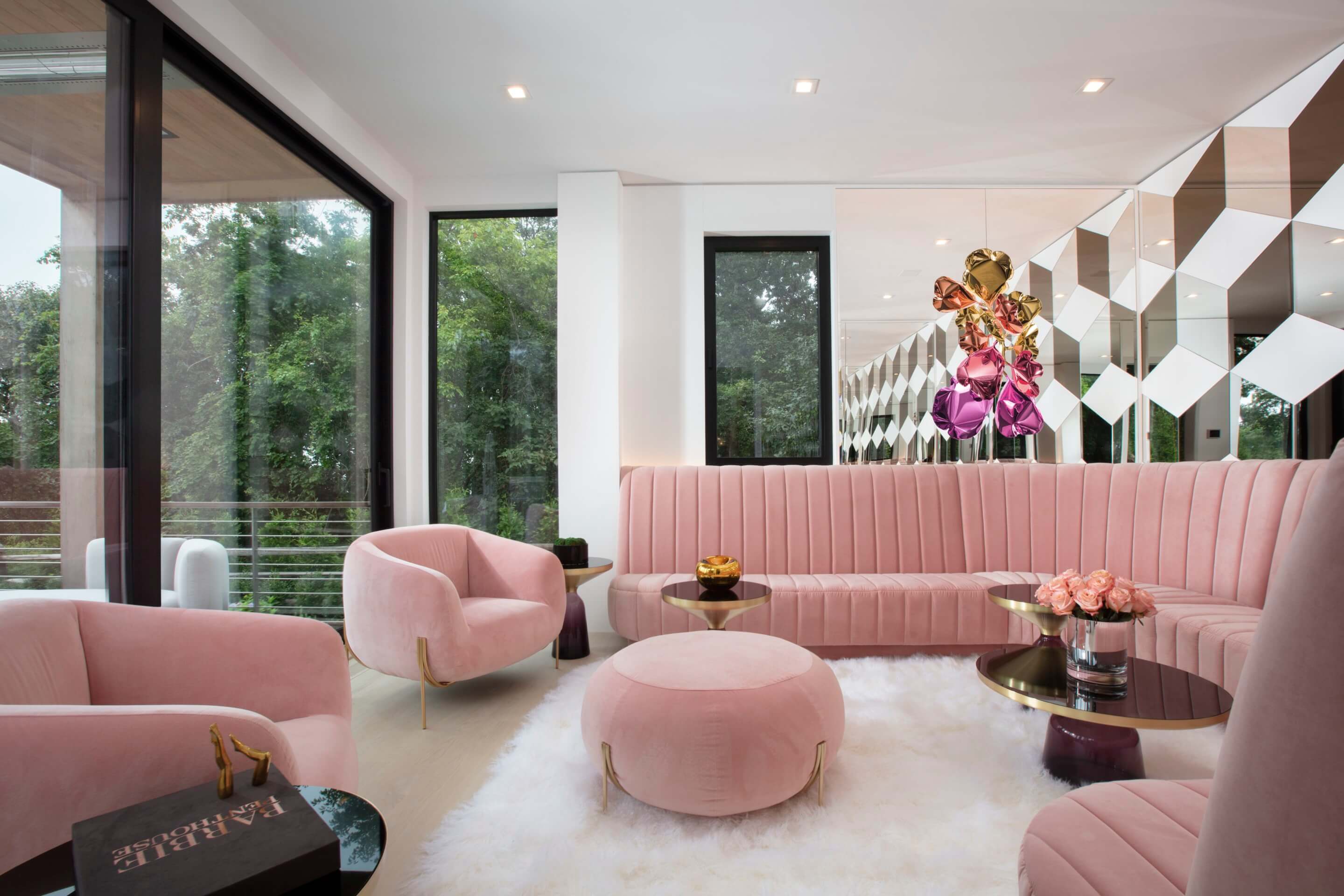 photograph depicting a domestic living room filled with plush pink furniture