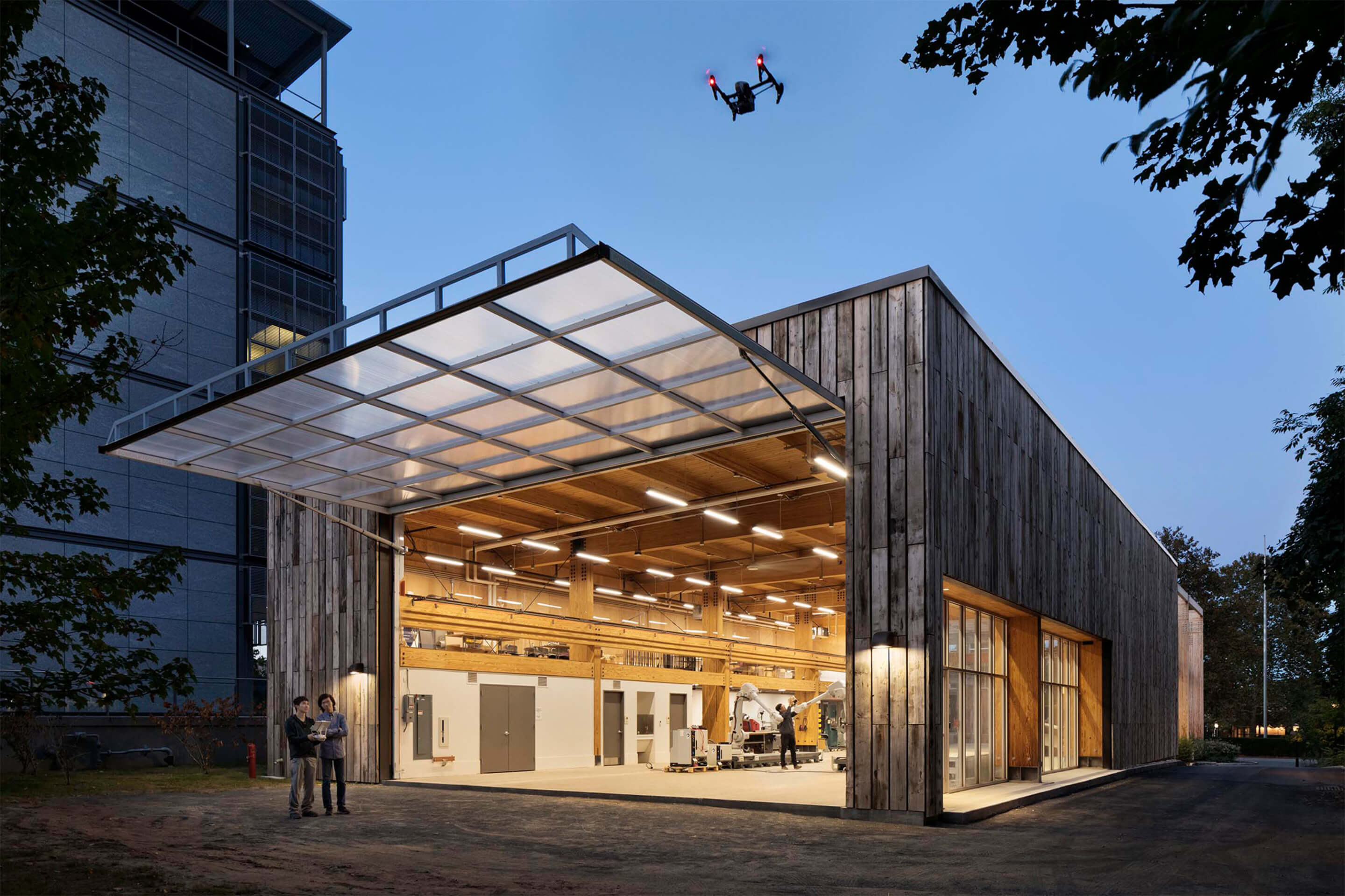 photograph depicting a shedlike structure with an open garage door and drone in the foreground