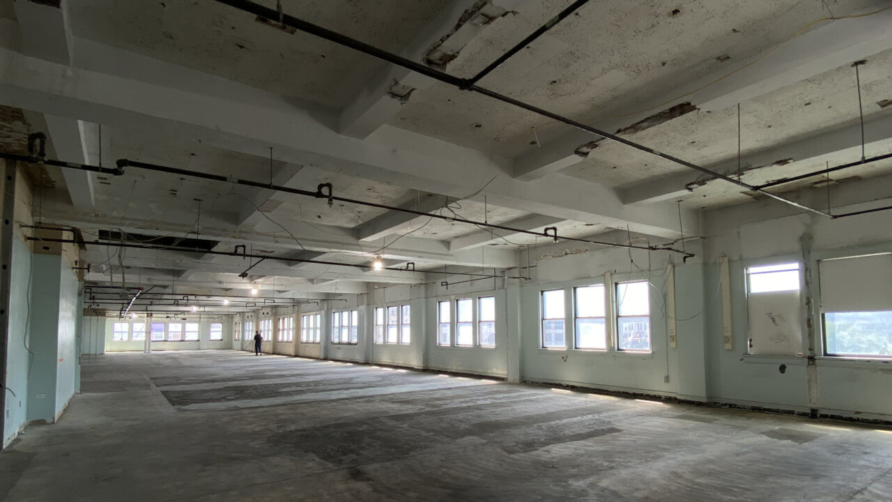Inside of a gutted warehouse with coffered ceilings