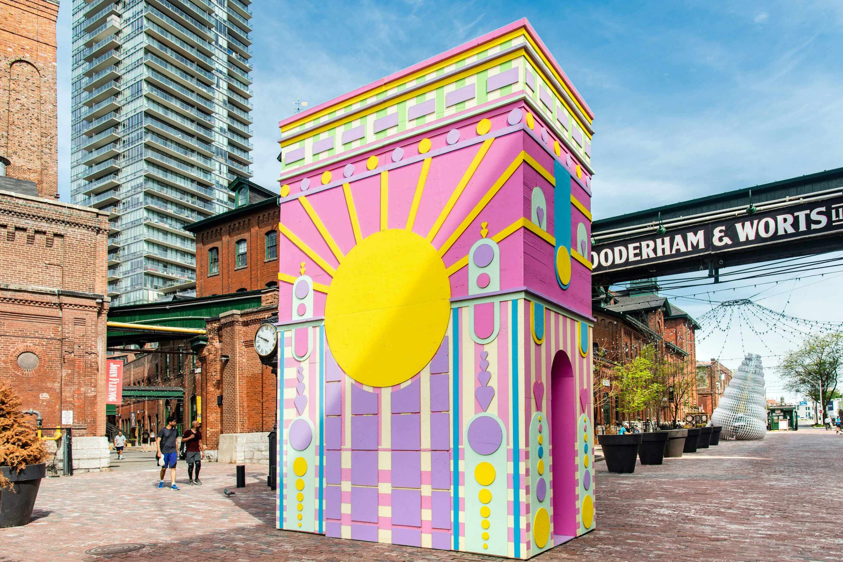 a pastel-colored installation place in busy public square