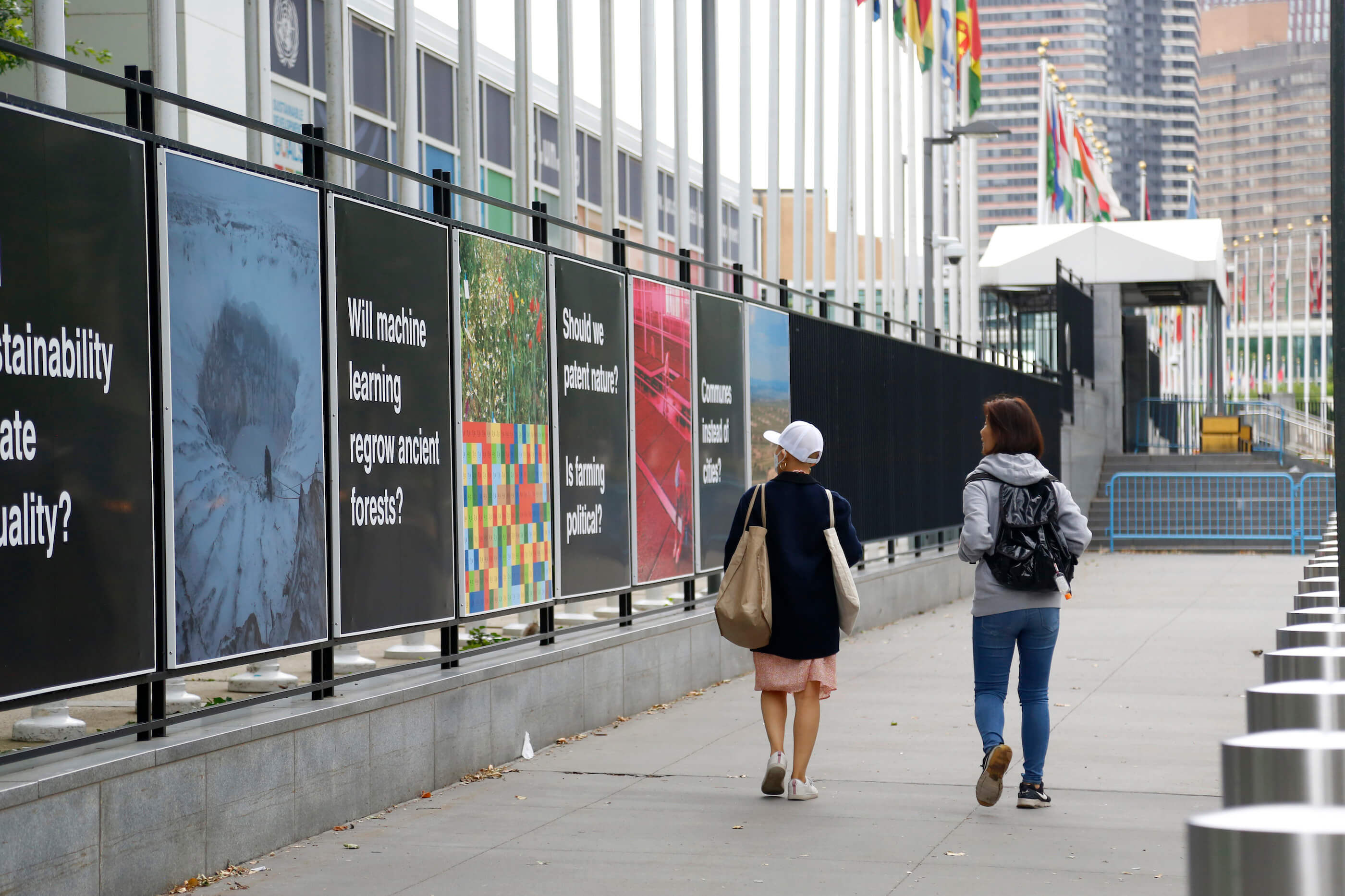 people view panels beneath flags at the UN
