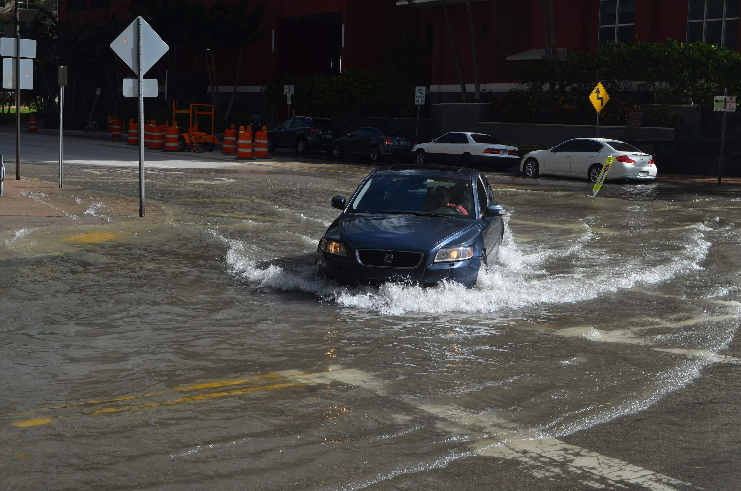 A car driving through a flooded street