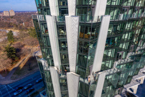 Looking at the jagged curtain wall of the One hundred tower, with vertical louvers between glass