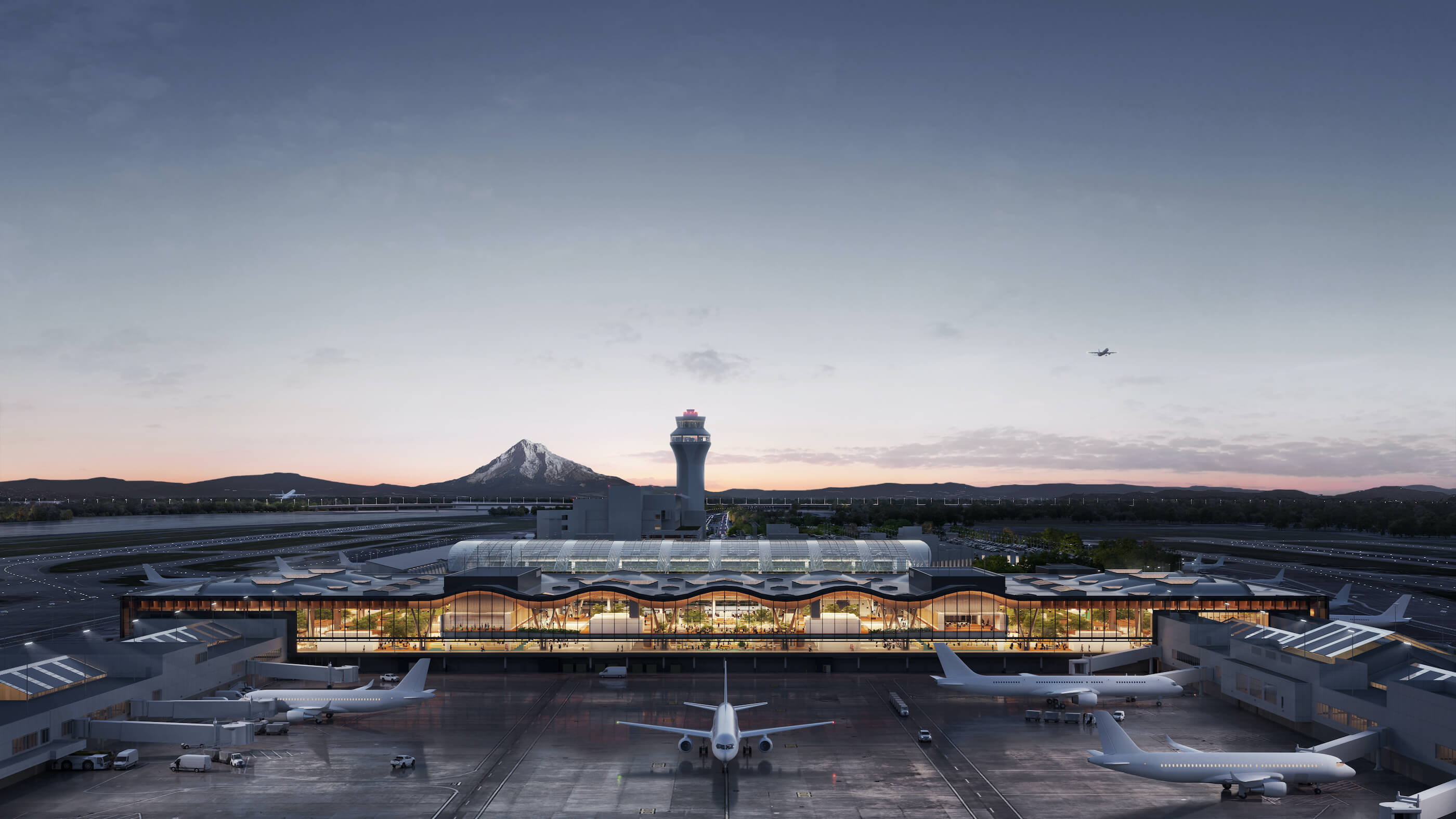bird's eye rendering of an airport terminal at dusk with a mountain in the background