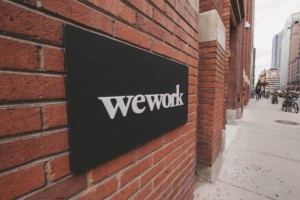 a brick wall with a wework sign on it