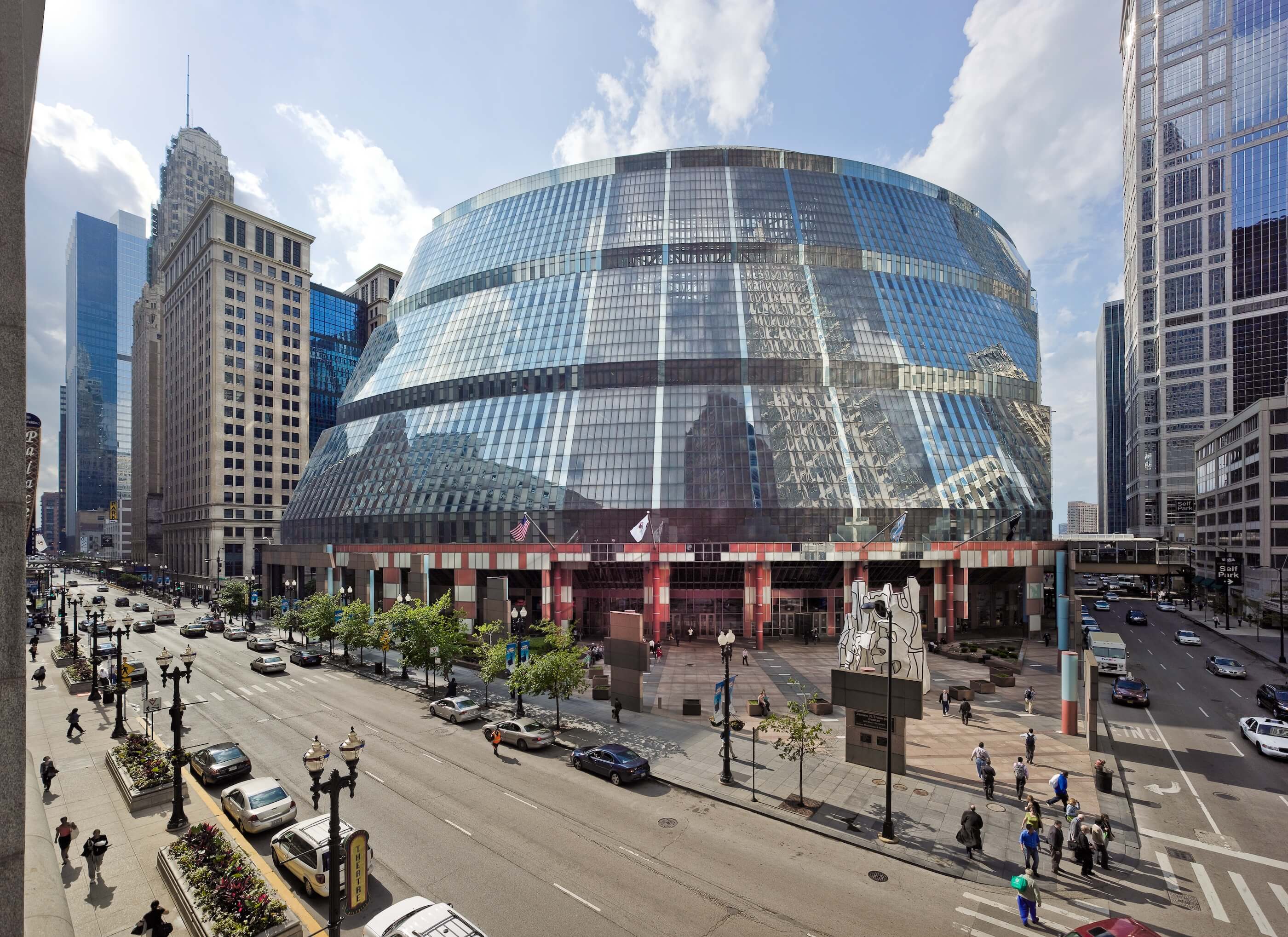 exterior view of a futuristic glass building in a city