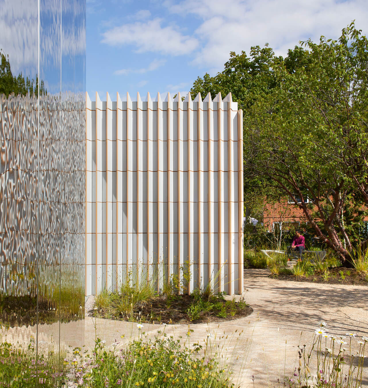 a long wall clad in ridged ceramics carving up space at a maggie's centre