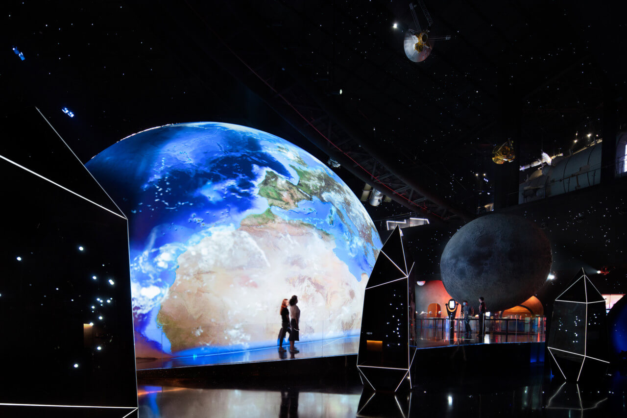a large view of a digital planet earth in a museum exhibition