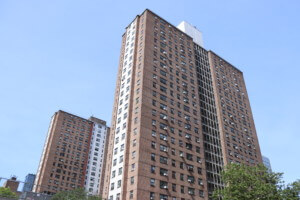 A public housing tower with a white stripe, one of many overseen by HUD