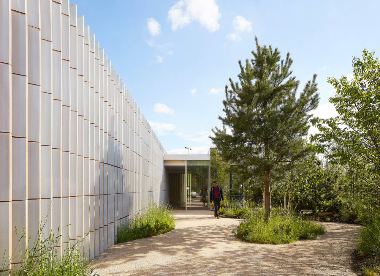 a long wall clad in ridged ceramics carving up space at a maggie's centre