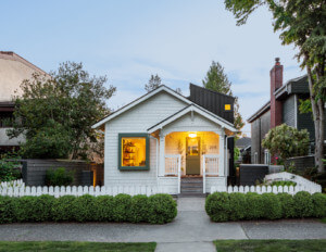 a small, white-painted bungalow with picket fence redesigned by best practice