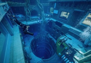 a diver descends into the fake ruins of an underwater city