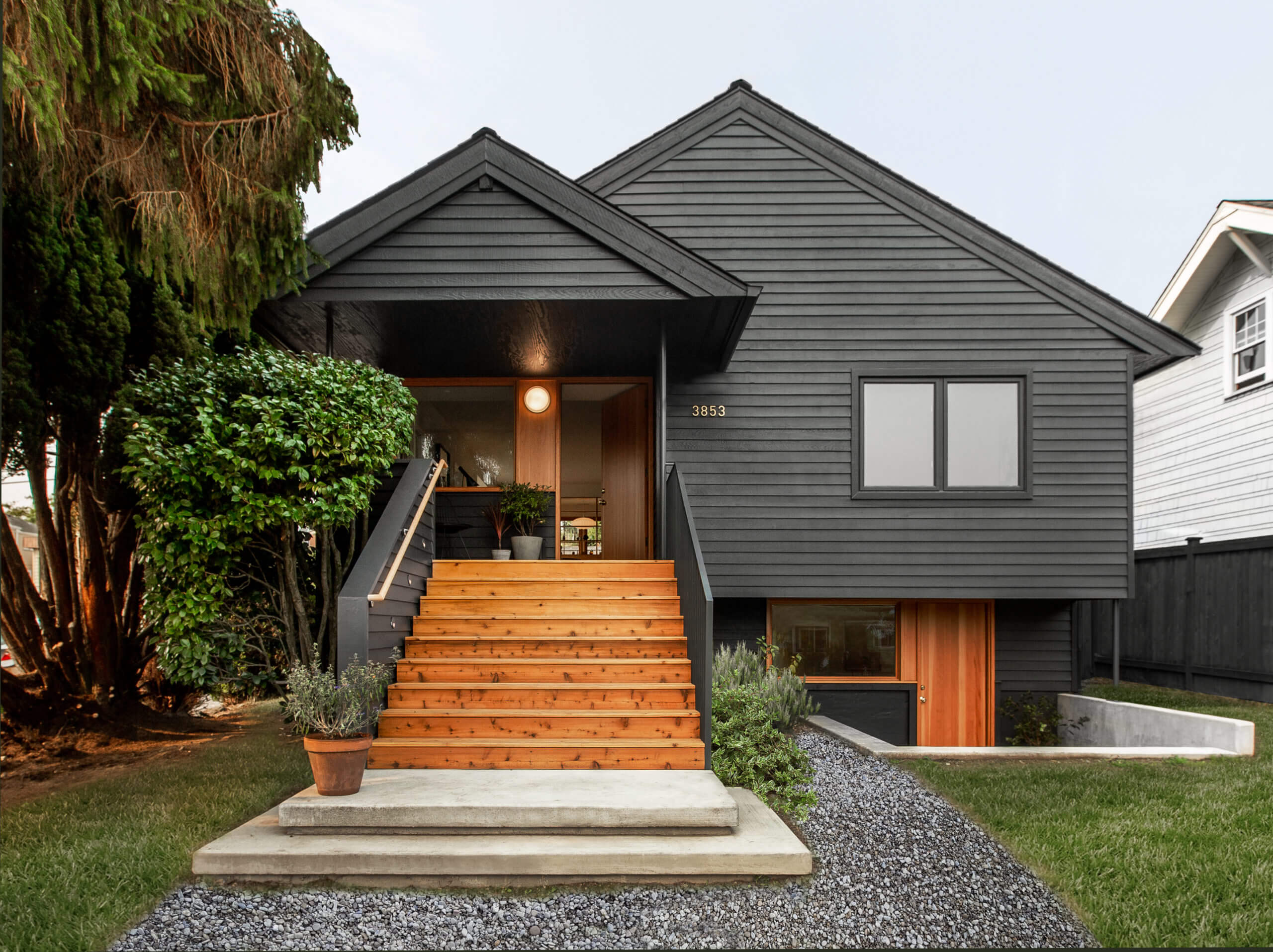 Photo of a house painted black with new wood stairs
