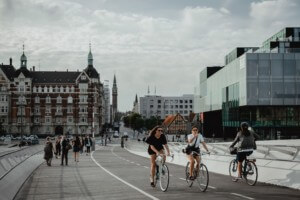 The skyline of copenhagen with people riding bicycles