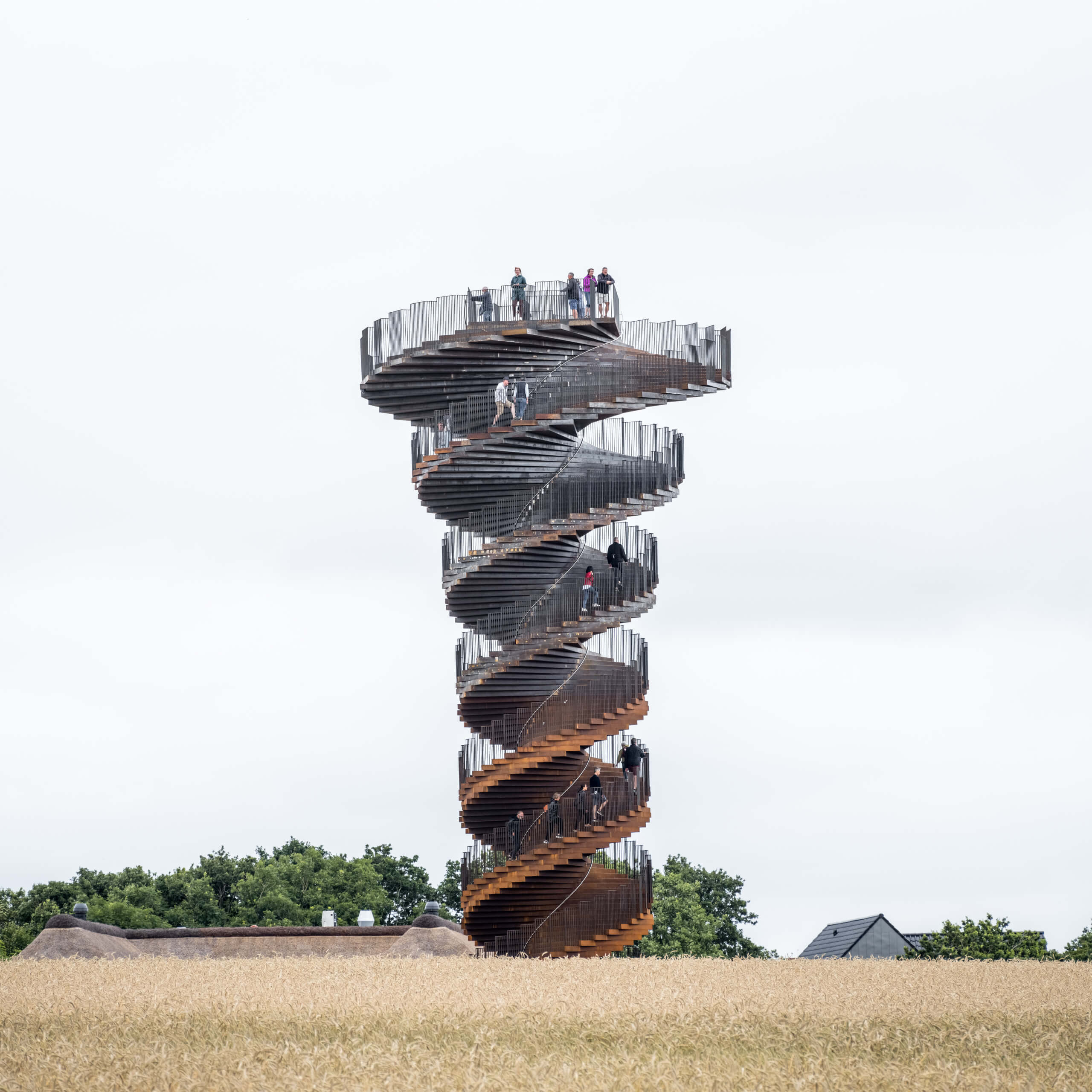 people climb a twisting staircase tower