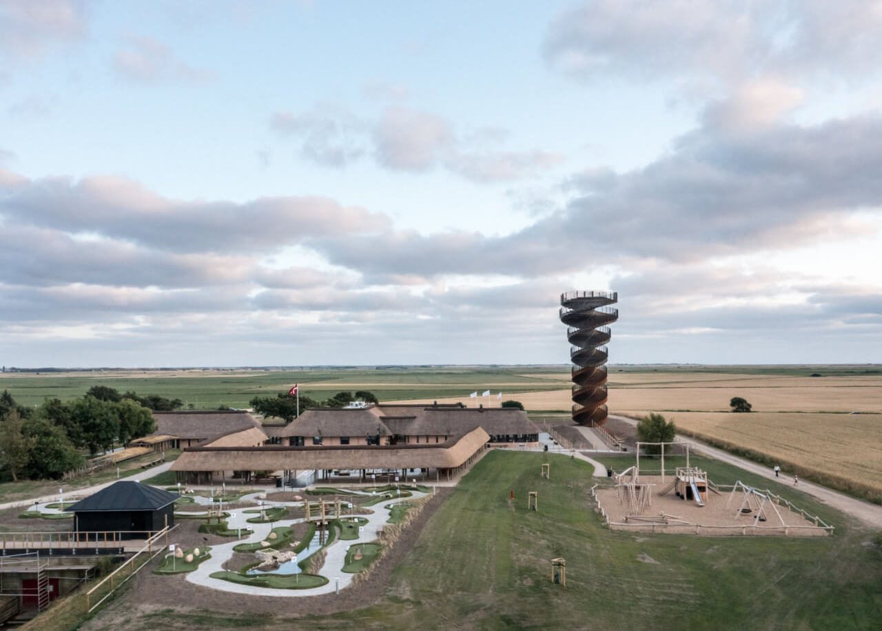 view of an observation tower surrounded by a campsite and farmland