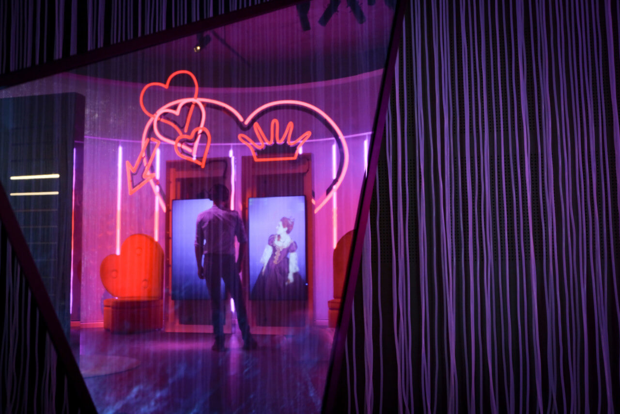 a red and purple light installation in a museum celebrating Hans Christian Andersen