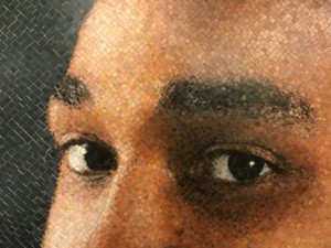 A chuck close mosaic of a man's face