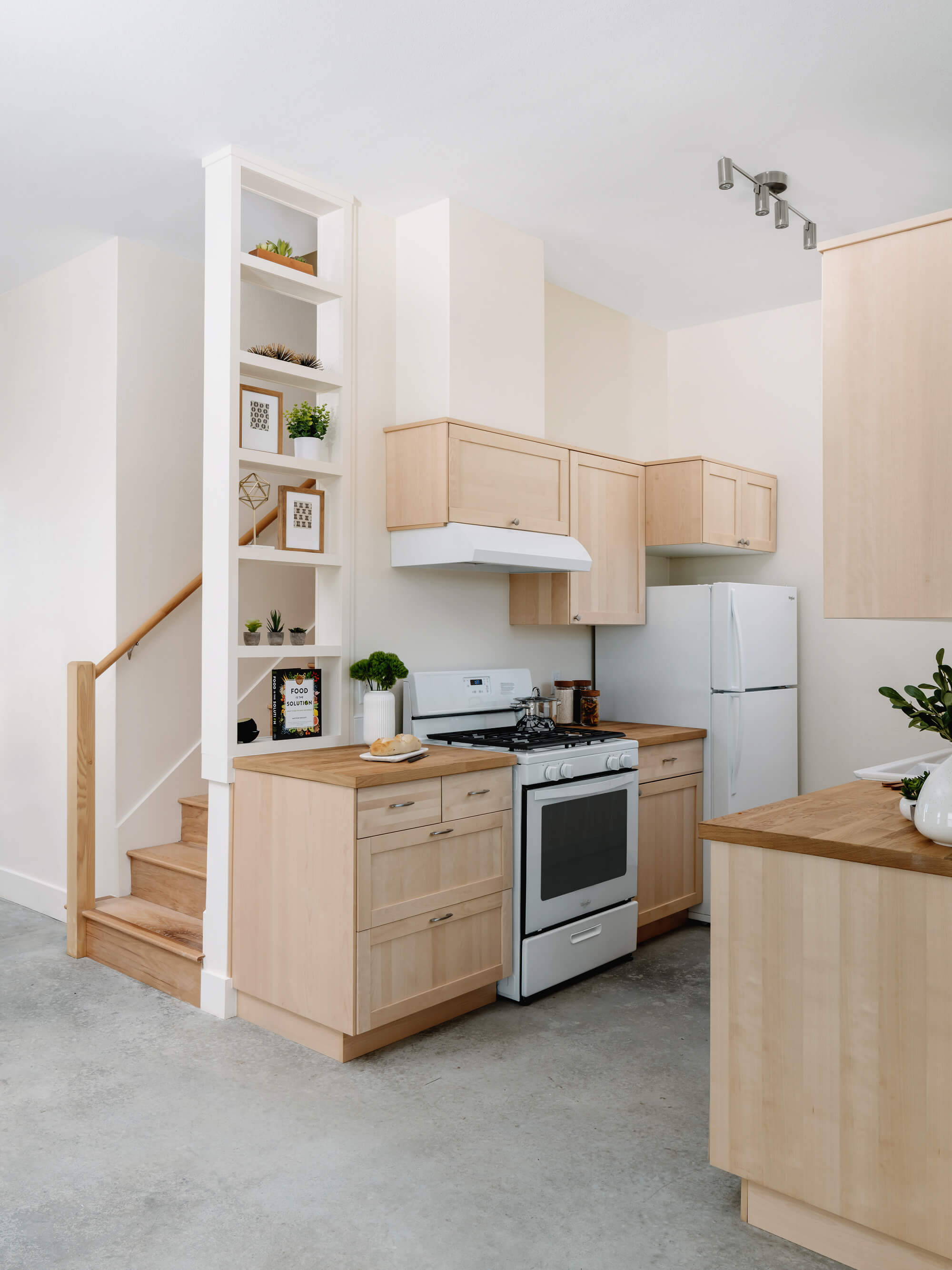 Interior photo of a kitchen with blond wood and white walls