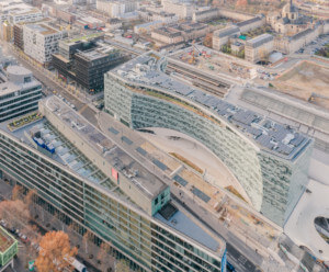 An aerial photo of a curved glass building