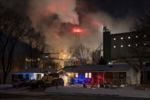 In Minnesota, industrial steam billows behind a house, part of the scope of the 2021 exhibit columbus