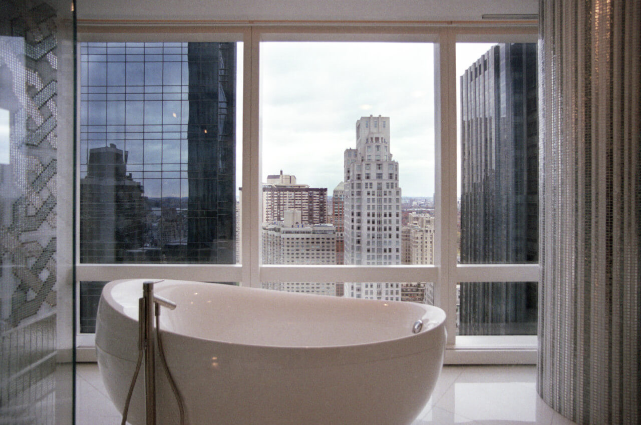 Looking out at a tub and the manhattan skyline