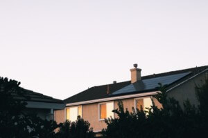 a home topped with pv panels pictured at dusk, not subject to the new california solar mandate