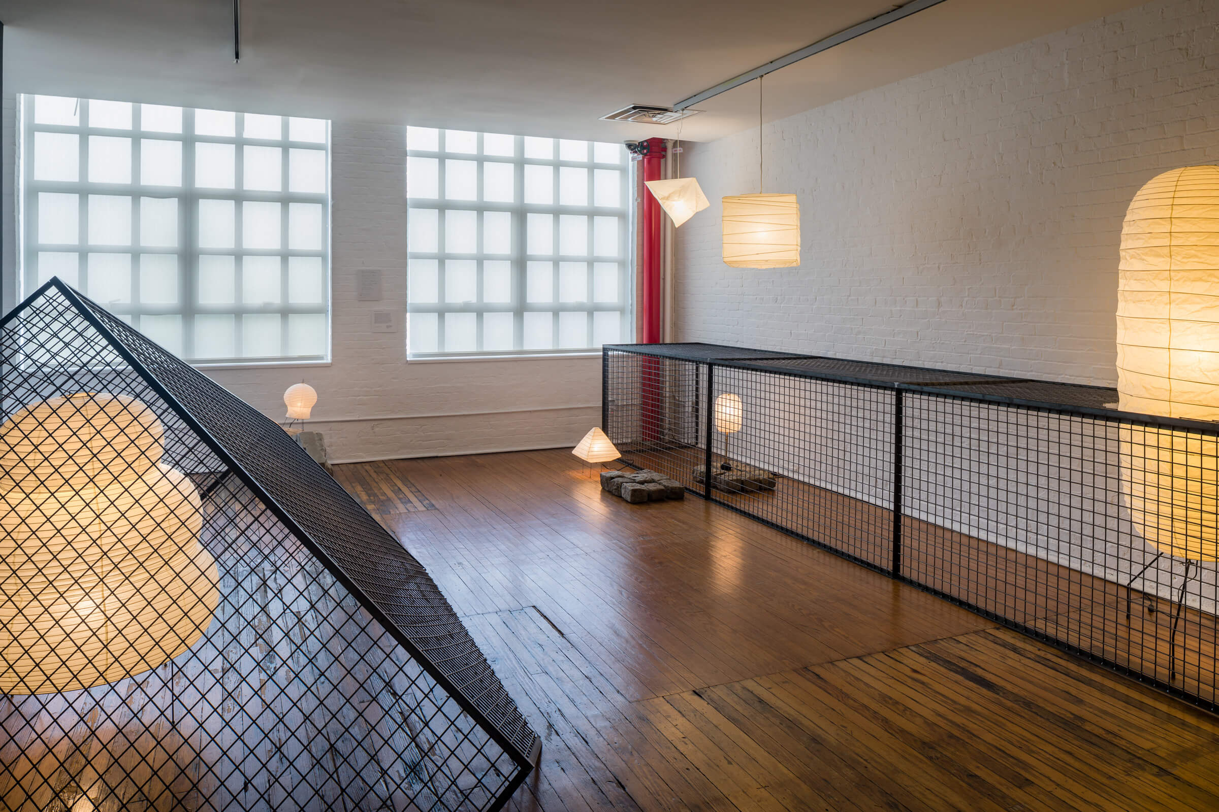 interior photo of useless architecture showing light fixtures constrained by cages