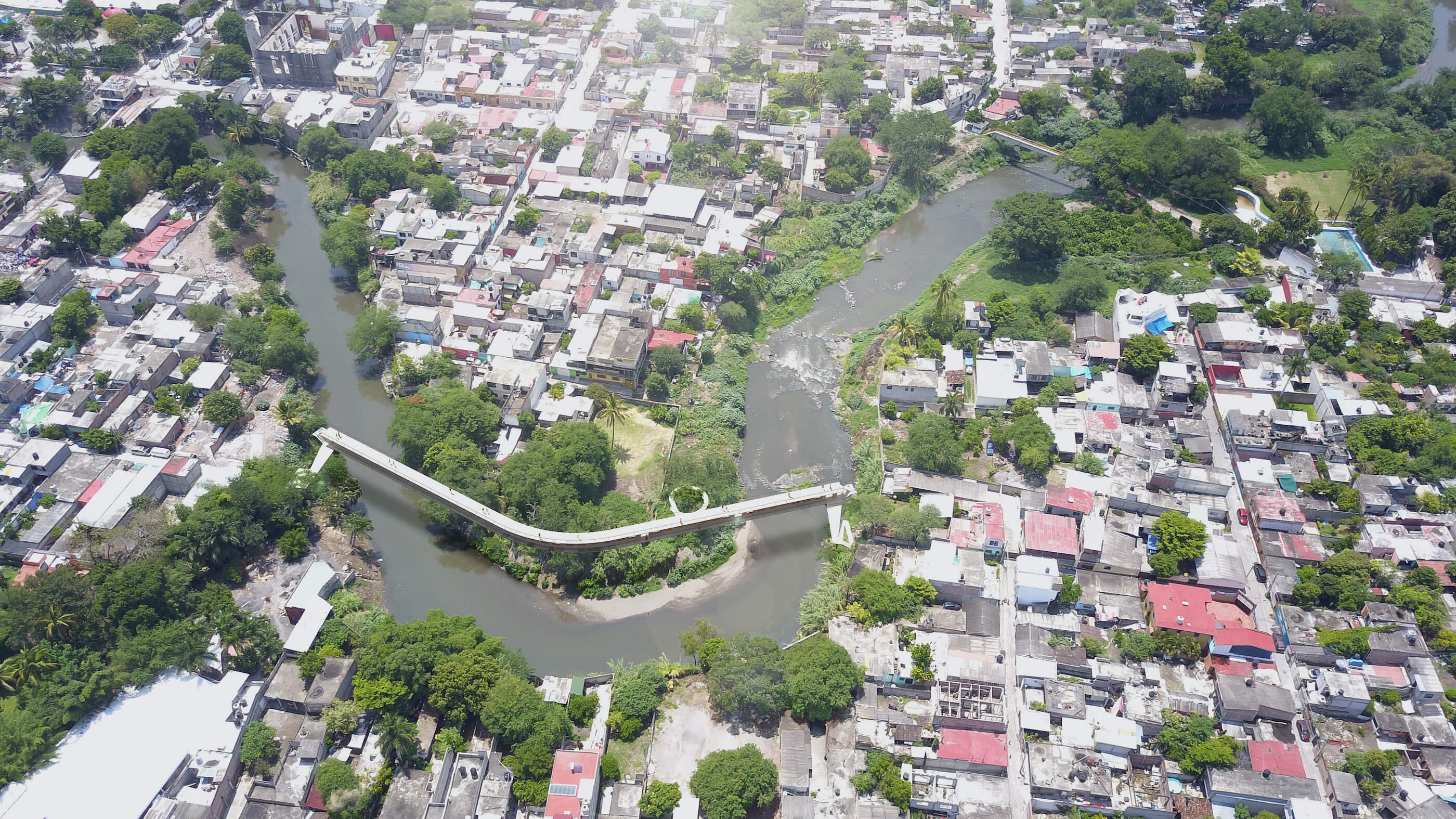 aerial view of a river-spanning pedestrian bridge