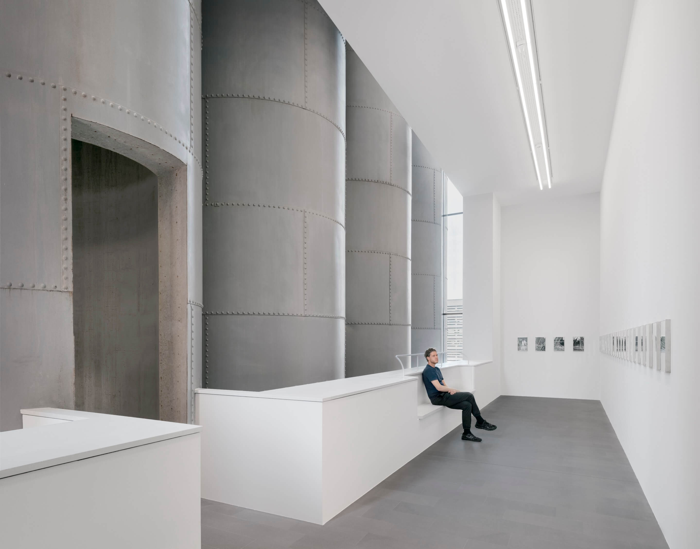 steel grain silos inside of a gallery space